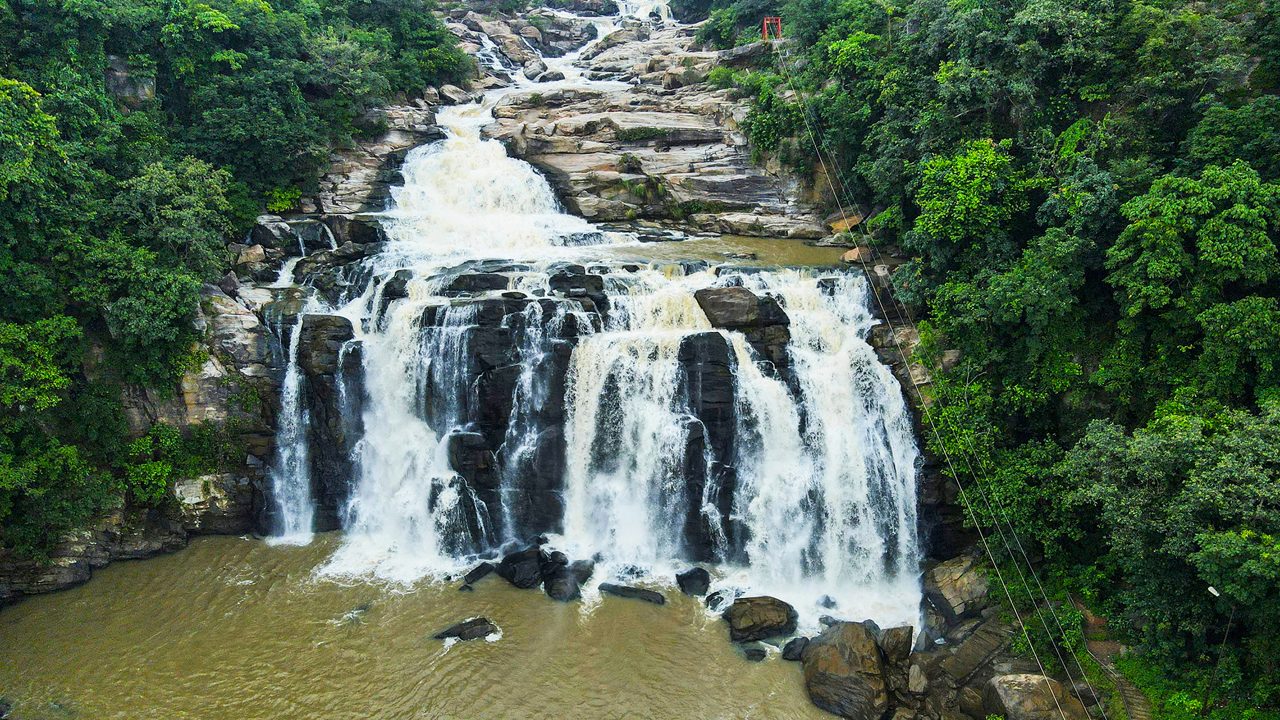 A scenic view of Dassam Falls cascading through lush greenery in Jharkhand.