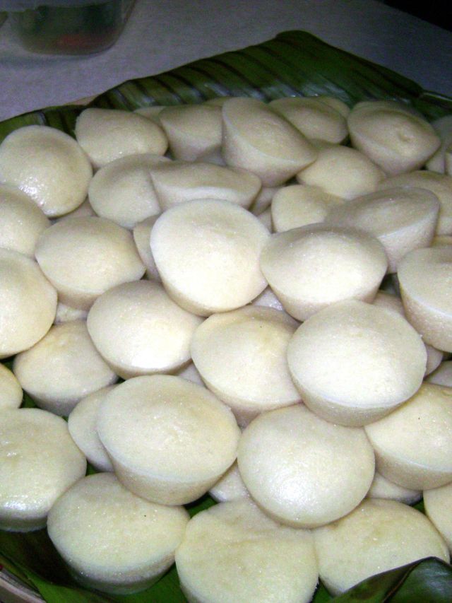 Steaming Pumaloi cakes over wood fire in rural Meghalaya village - traditional cooking method.