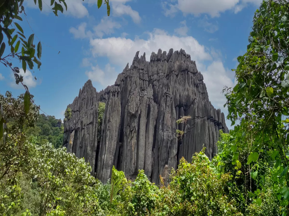Unique limestone rock formations surrounded by lush forests and mythological significance.