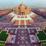 Grand Hindu mandir with carved sandstone pillars, boat rides, and laser shows.