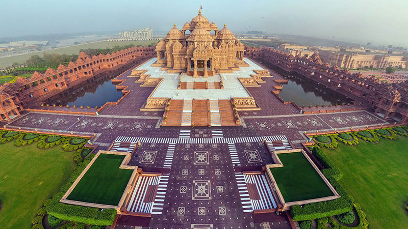 Grand Hindu mandir with carved sandstone pillars, boat rides, and laser shows.