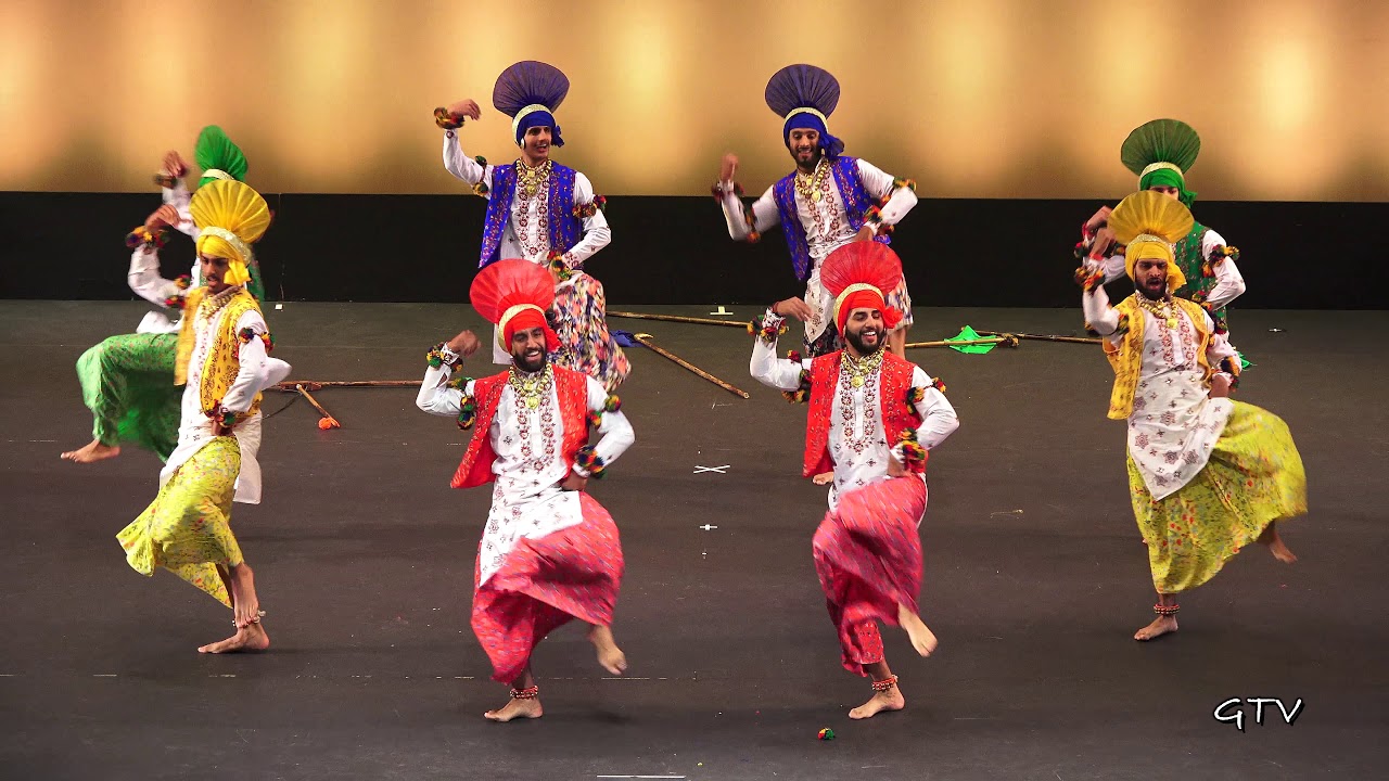 Delhi Punjabi festival with bhangra dancers in bright turbans and gidda performers clapping in circles.