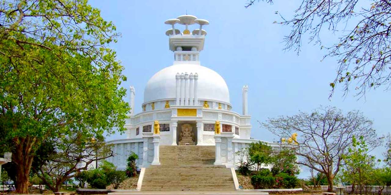 A white peace pagoda marking Emperor Ashoka’s transformation after the Kalinga War.