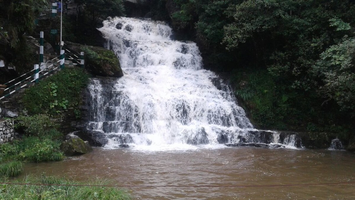 Three-tiered Elephant Falls near Shillong - cascading waterfalls surrounded by lush forest in Meghalaya.