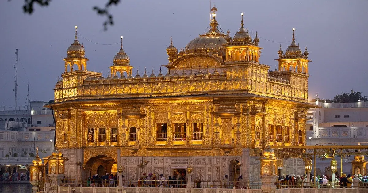 The holiest Sikh gurudwara in Amritsar, Punjab with golden architecture reflecting in sacred pool.