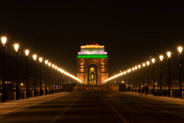 India Gate war memorial in Delhi - 42-meter tall arch honoring soldiers, surrounded by lush lawns and evening lights.