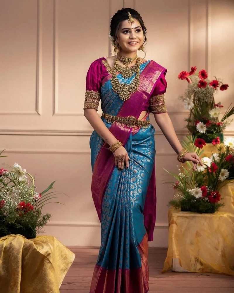 One of the most popular Indian traditional dresses of Luxurious silk sarees with bold colors and intricate gold zari work, worn especially at weddings and festivals.