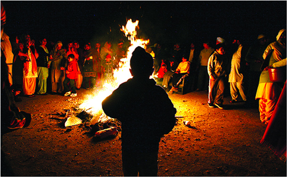 Winter festival with bonfires, songs, and traditional sweets in Punjab.