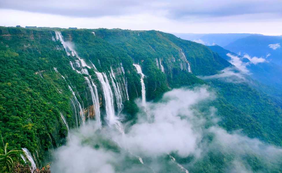 Misty village landscape of Mawsynram, Meghalaya - world's rainiest place with lush greenery.
