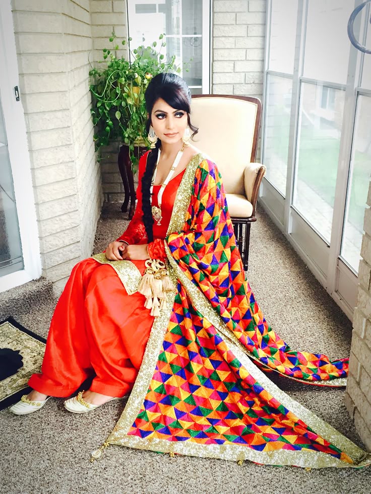 Colorful dupattas and salwar suits adorned with thick, floral threadwork.