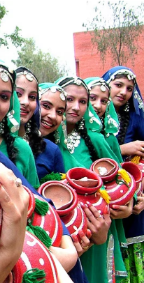 Graceful women's dance with silver jewelry and rhythmic movements in Punjab.