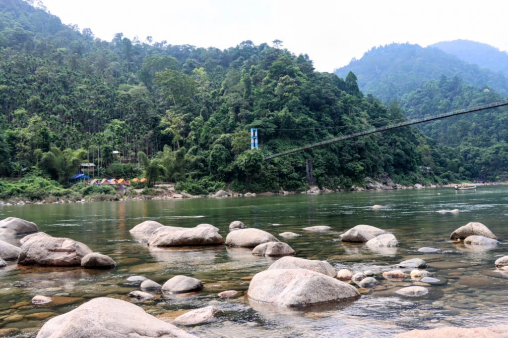 Camping by the river in Shnongpdeng - crystal clear waters near Dawki in Meghalaya.