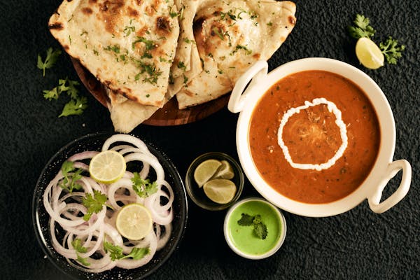 North Indian cuisine is known for its rich, flavorful dishes featuring spices, breads like naan, and hearty curries such as butter chicken and dal makhani.