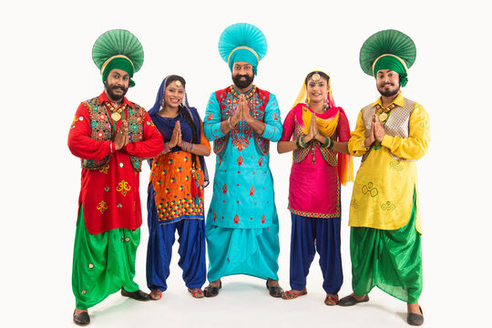 Colorful dupattas and salwar suits adorned with thick, floral threadwork.