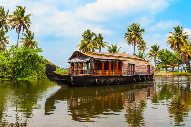 Traditional houseboat cruising through Alleppey’s backwaters, a scenic escape.