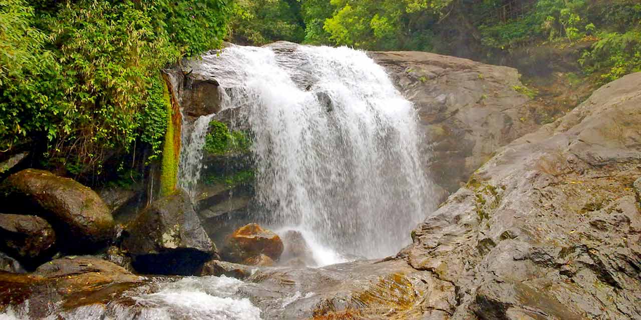 Twin waterfalls cascading through Munnar’s rocky cliffs.