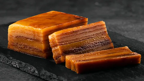 Goa’s famous layered Bebinca – a caramelized coconut cake with seven sweet layers, often enjoyed at festivals.