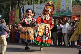 Folk dancers wearing Butta Bommalu masks in Andhra Pradesh celebration.