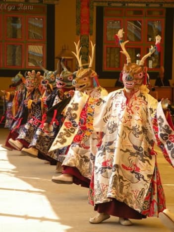Monks in elaborate masks performing sacred Chham dance at a monastery in Himachal Pradesh