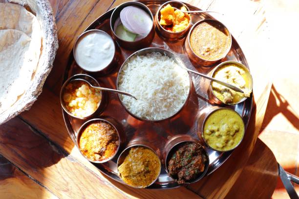 Traditional Himachali Dham meal served on leaf plates during festive celebrations