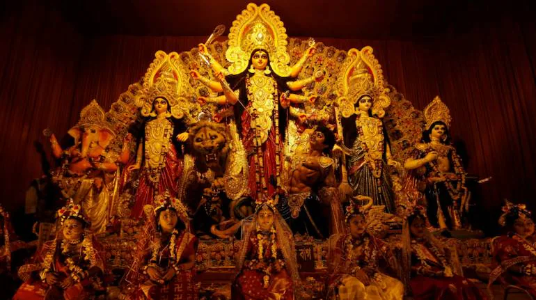 Elaborate Durga Puja pandal with artistic idol and festive crowds