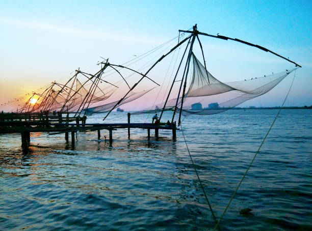 Serene Fort Kochi Beach with Chinese fishing nets and colonial-era architecture.