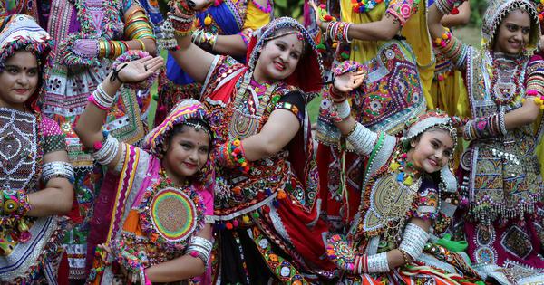 Dancers performing traditional Garba in colorful attire in Gujarat.
