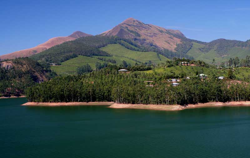 Scenic hill station in Munnar with misty mountains and tea gardens.