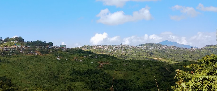 Tranquil Saitual village lake reflecting surrounding hills, scenic place to visit near Aizawl