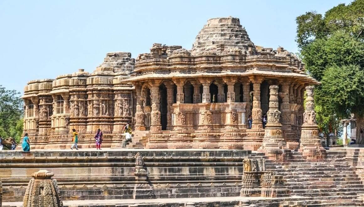Tourists exploring the intricately carved Sun Temple in Gujarat’s Modhera.