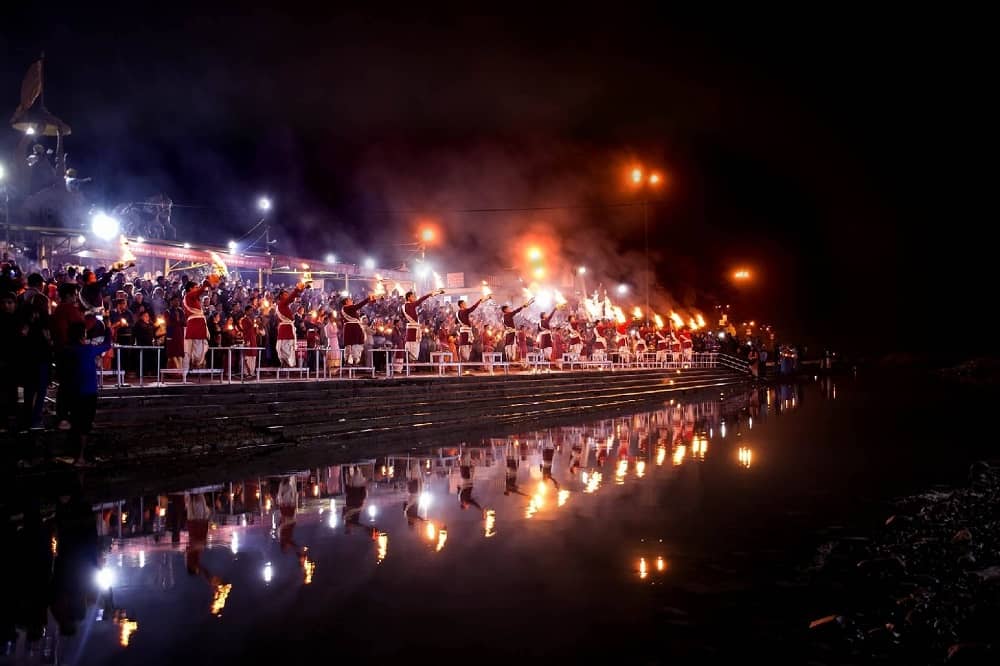 Witness the holy confluence at Triveni Ghat in Rishikesh, where devotees gather for divine dips.