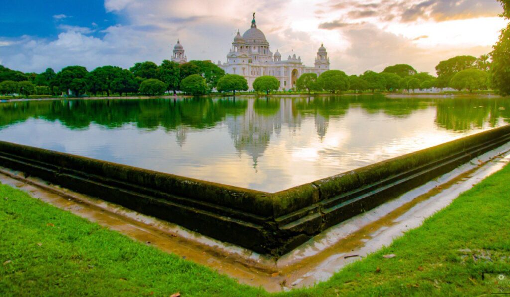 Majestic white marble Victoria Memorial Hall in Kolkata, showcasing British colonial architecture against blue skies.