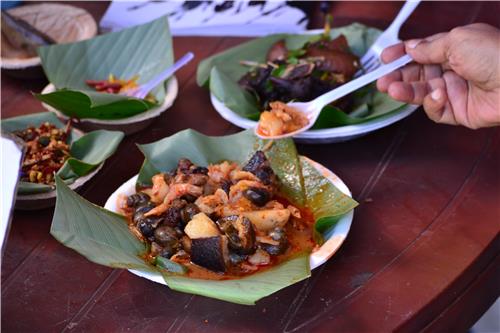 Traditional Akibi dish being prepared with local Naga ingredients