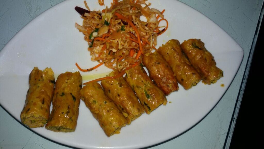 Fried or steamed snacks made from rice and pulses, flavored with local spices.