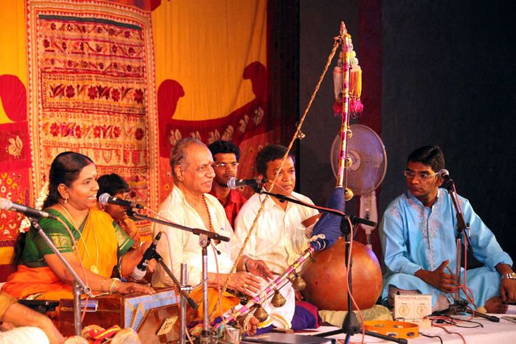 Traditional Villu Paattu folk music performance in Puducherry using bow-shaped instrument.