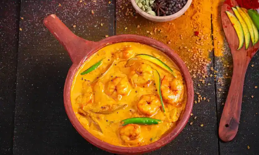 Spicy Chettinad seafood curry served in a Puducherry beachside restaurant.