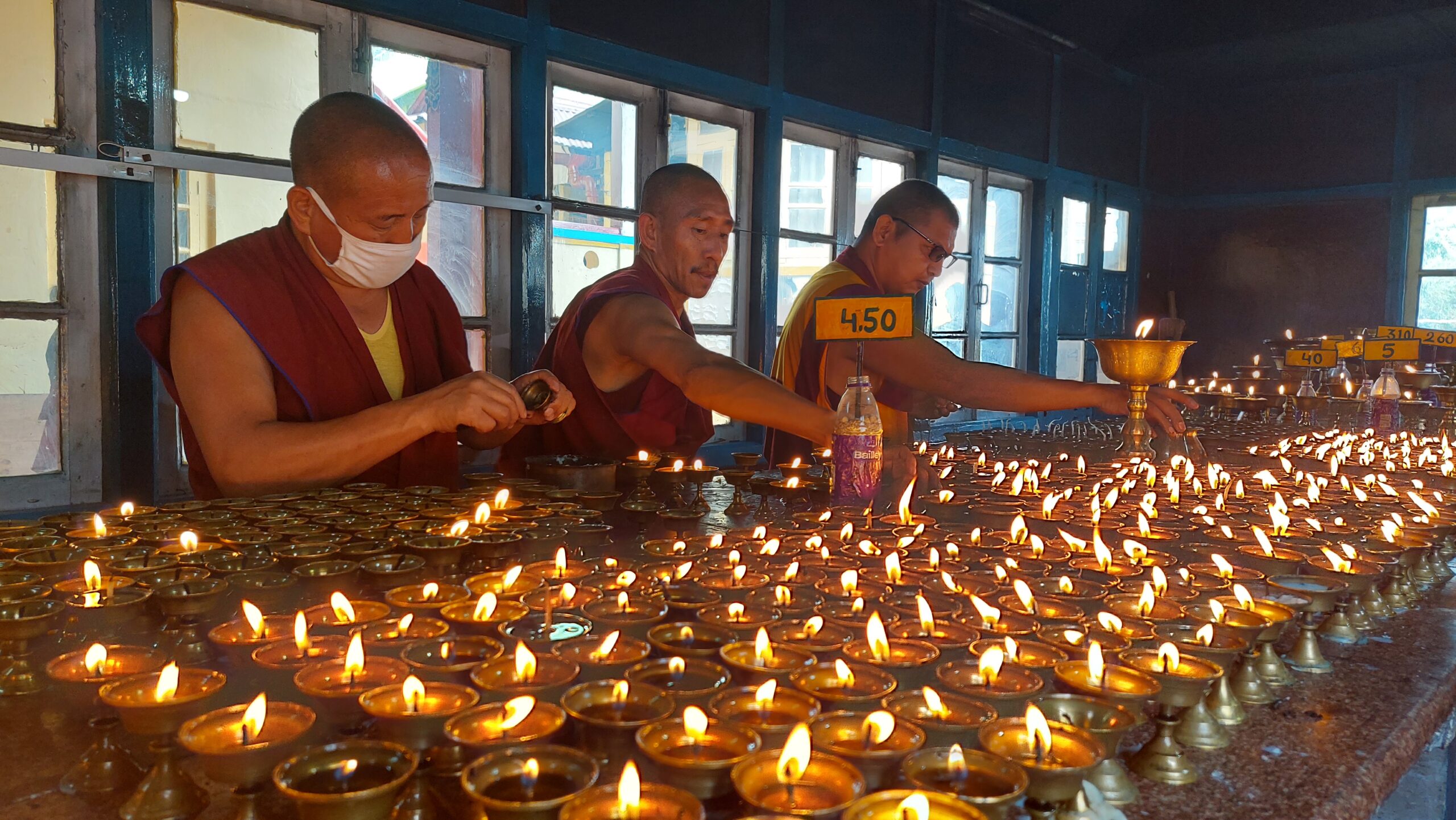 Monks lighting Diya's together for peace