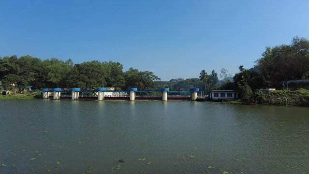 Picturesque dam with temple and small waterfalls