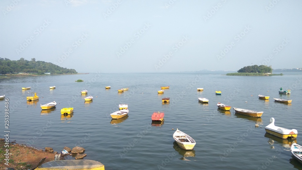 Serene boat ride on Bhopal’s Upper Lake at sunset, with cityscape reflections.