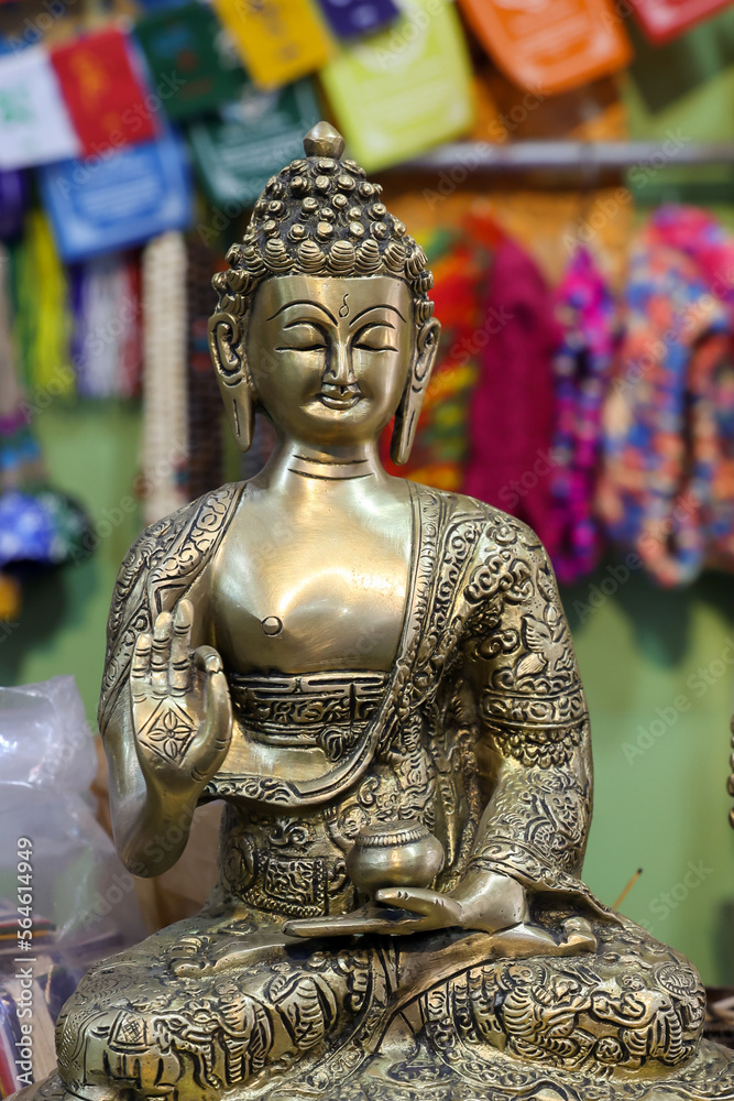 Rows of small Buddha statues with colorful prayer flags