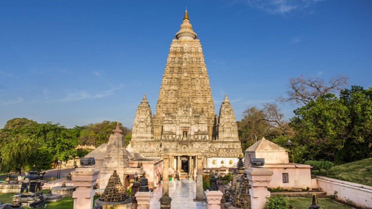 Golden spire of Mahabodhi Temple glowing at sunrise