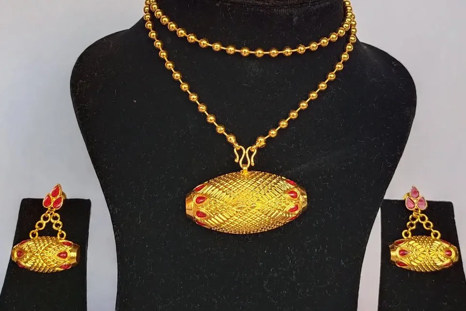 Half moon shaped jewelry wore with mekhela sador