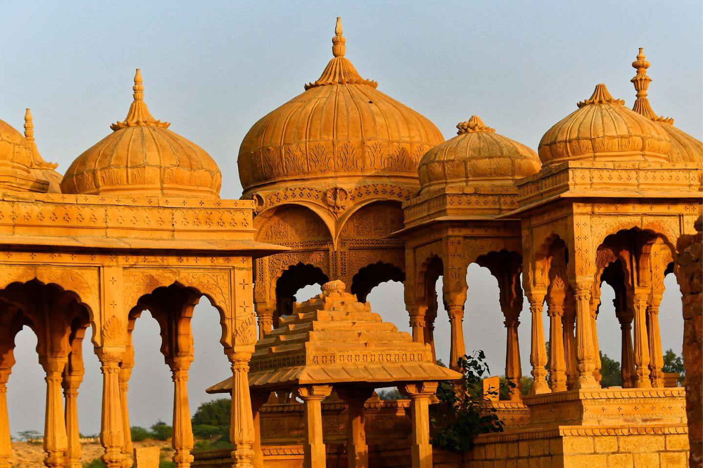 Golden sunset over Vyas Chhatri cenotaphs overlooking Jaisalmer city