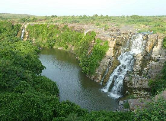 A breathtaking waterfall near Nagarjuna Sagar, surrounded by lush greenery.