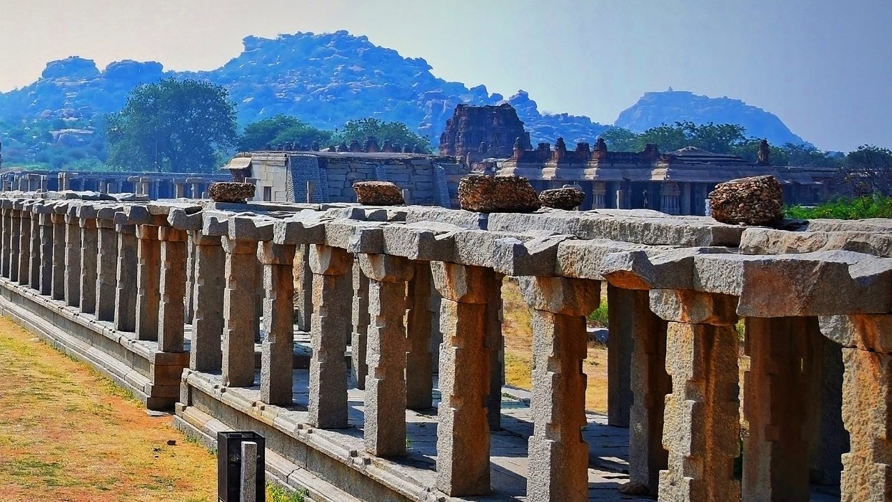 Ancient Hampi Bazaar lined with ruins and small shops