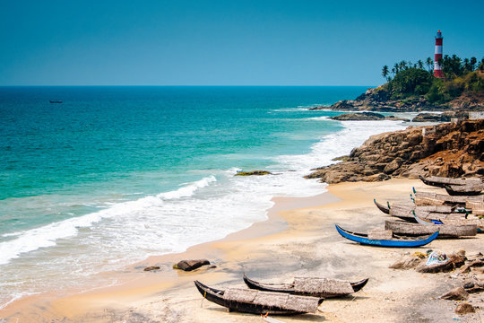 City Page Thiruvananthapuram: Palm-fringed shores and golden sands of Kovalam Beach at sunset.