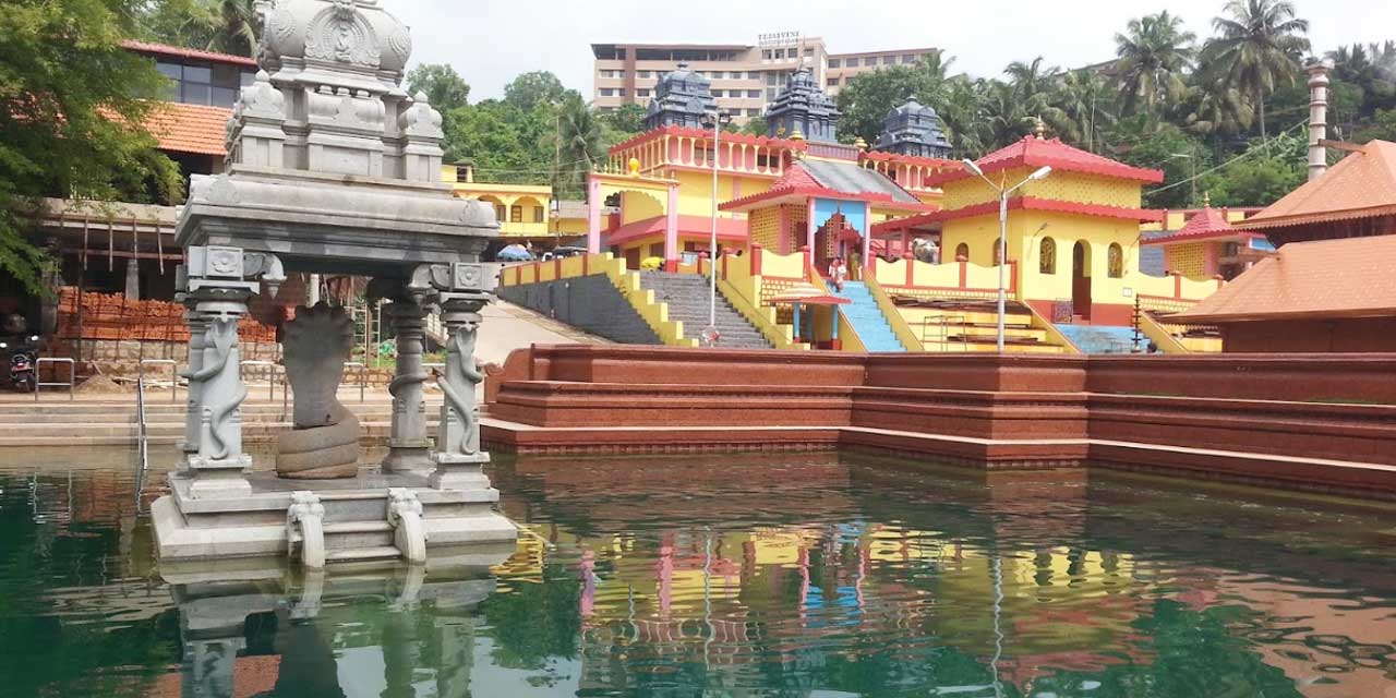 An ancient temple surrounded by lush greenery and a sacred pond.