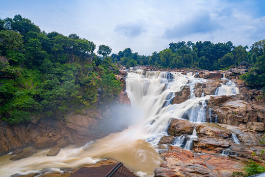 Powerful cascade of Lodh Falls in dense forest