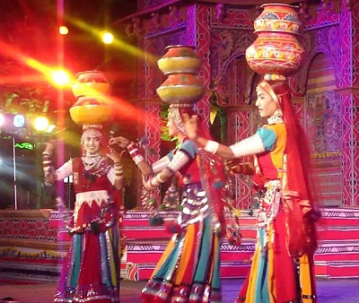 Women balancing matka pots during traditional dance