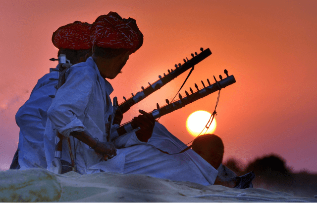 Coorg City Page features Kodava patriotic ballads being performed in traditional attire at a cultural event